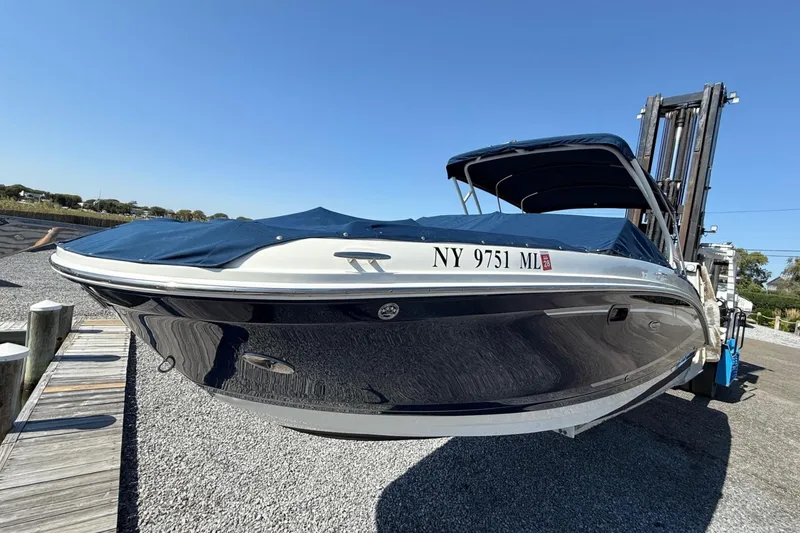 Slide: The Image of 2016 Sea Ray 270 Sundeck boat with cover, docked on gravel. - 4