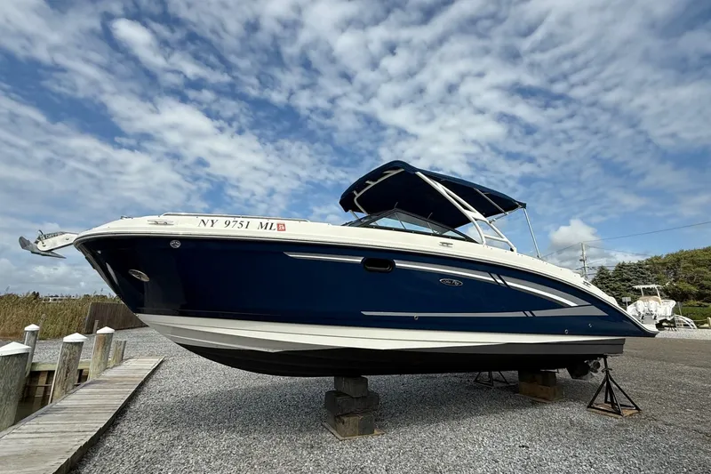 Slide: The Image of 2016 Sea Ray 270 Sundeck boat on dry dock under a cloudy sky. - 5
