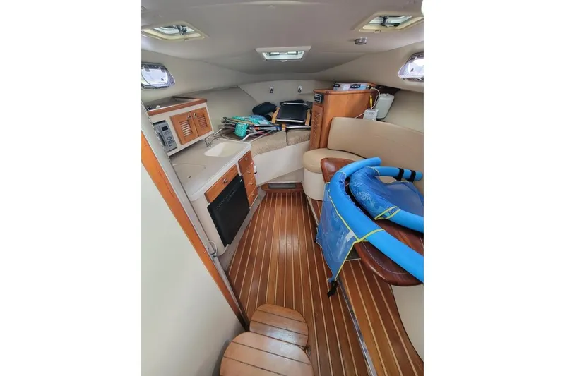 Slide: The Image of Interior of 2007 Pursuit OS 335 Offshore boat with wood flooring and seating area. - 13