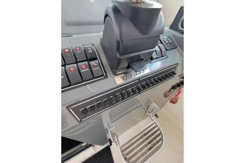 Slide: The Image of Control panel of a 2007 Pursuit OS 335 Offshore boat with switches and throttle. - 14
