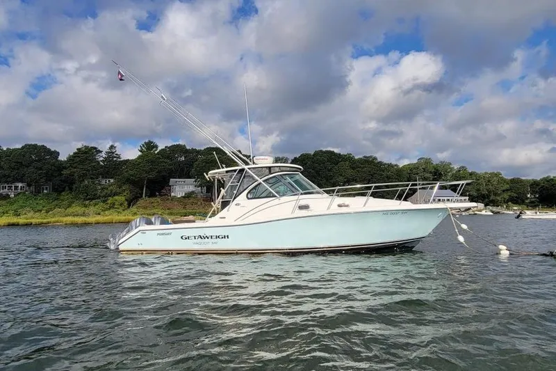 Slide: The Image of 2007 Pursuit OS 335 Offshore boat anchored on a scenic lake with cloudy sky. - 3