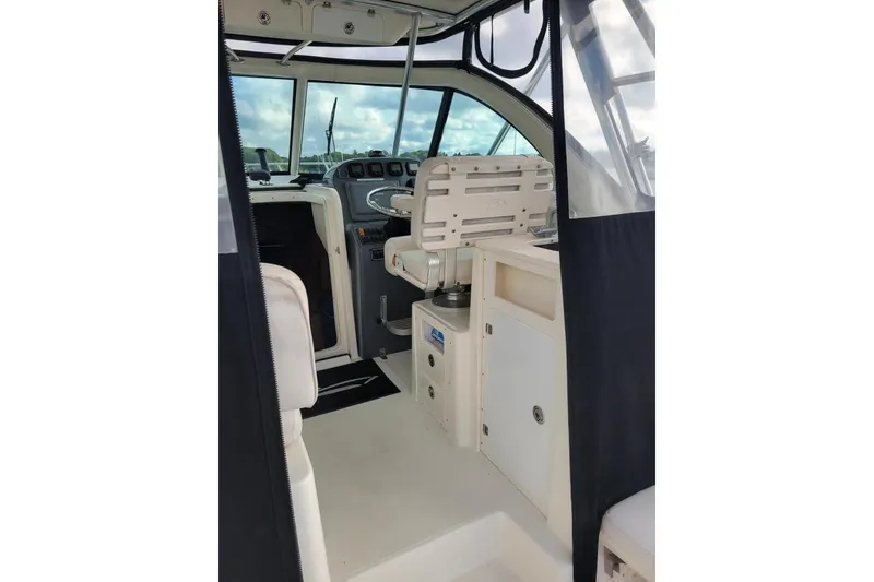 Slide: The Image of 2007 Pursuit OS 335 Offshore boat interior with helm and seating area. - 7