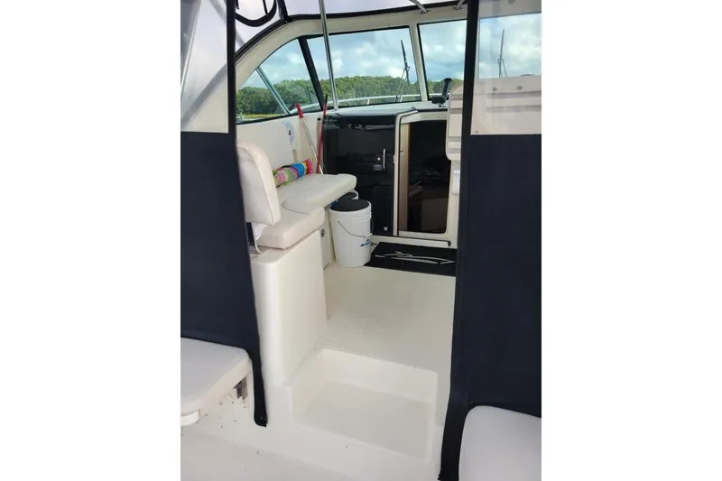 Slide: The Image of 2007 Pursuit OS 335 Offshore boat interior with seating and helm area. - 8