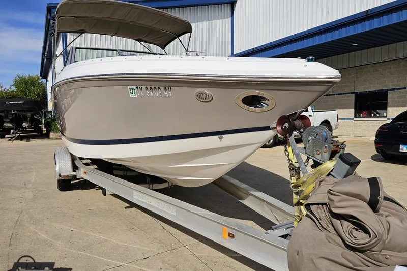 Slide: The Image of 2007 Cobalt 252 boat on trailer outside a building, sunny day. - 13