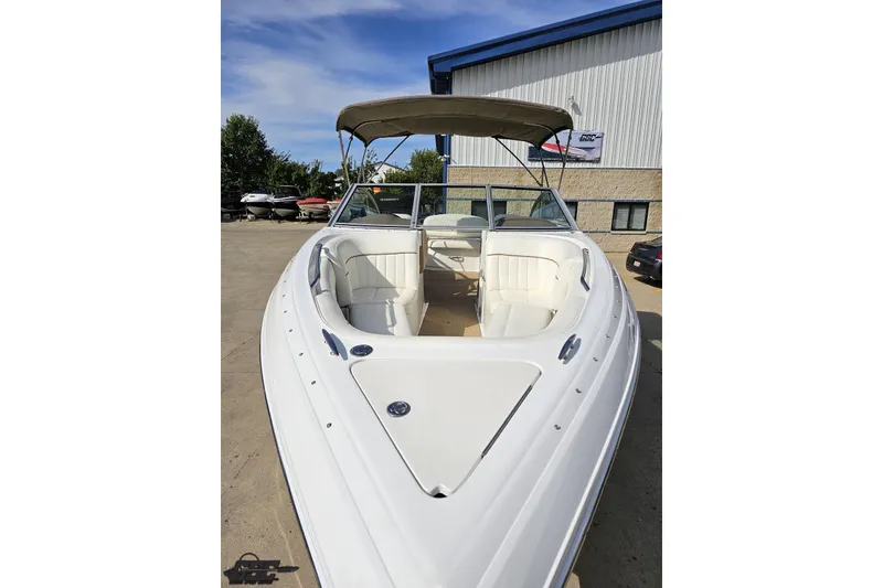 Slide: The Image of 2007 Cobalt 252 boat with white interior and canopy, parked outdoors. - 15