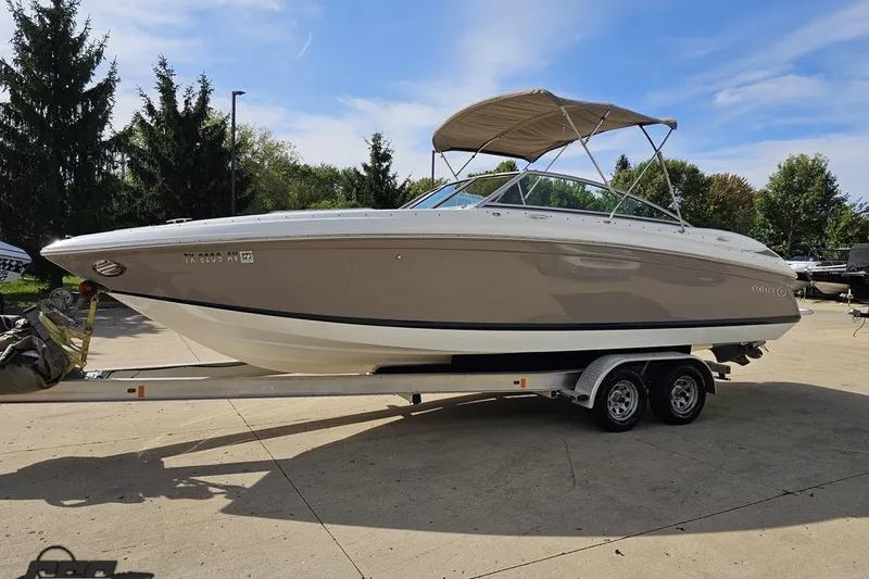 Slide: The Image of 2007 Cobalt 252 boat on trailer, parked outdoors under clear sky. - 18