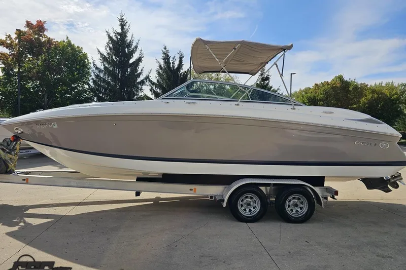 Slide: The Image of 2007 Cobalt 252 boat on trailer, parked outdoors under a clear sky. - 20