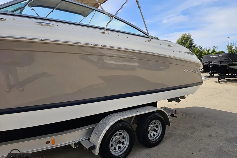Slide: The Image of 2007 Cobalt 252 boat on trailer, side view, outdoors, sunny day. - 22