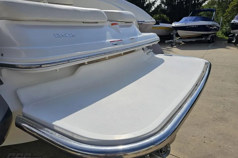 Slide: The Image of 2007 Cobalt 252 boat with a spacious swim platform in a marina setting. - 28