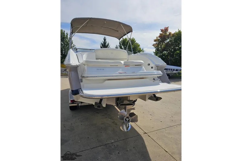 Slide: The Image of 2007 Cobalt 252 boat rear view with canopy, parked on concrete surface. - 29