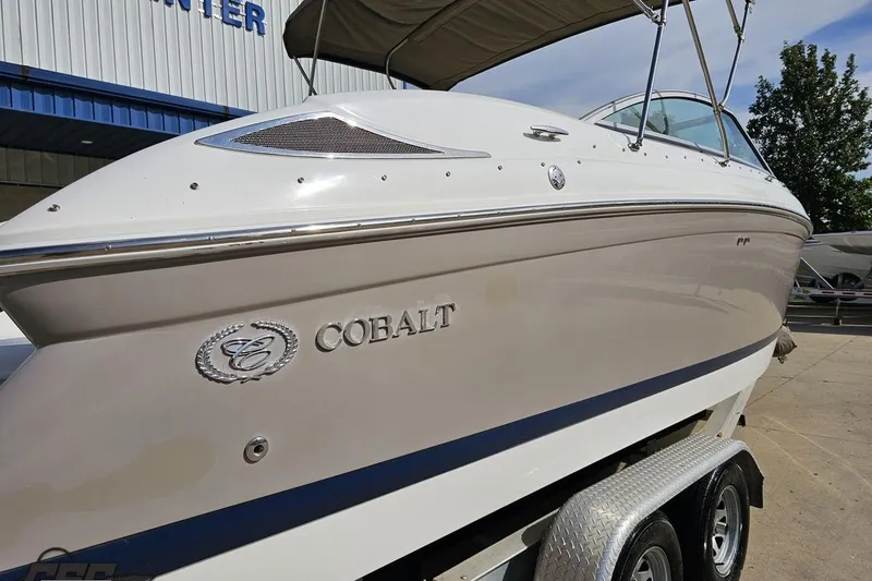 Slide: The Image of 2007 Cobalt 252 boat on trailer, side view with logo, outdoors. - 34