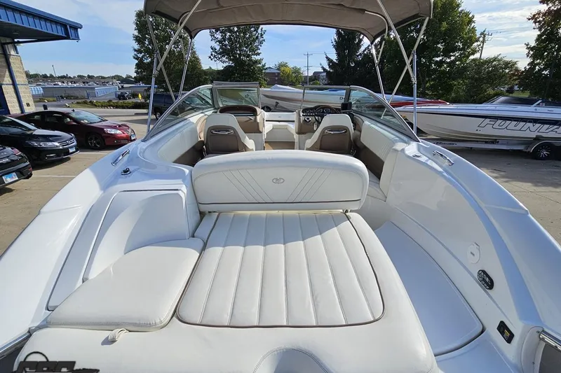 Slide: The Image of 2007 Cobalt 252 boat with white interior, parked outdoors under a canopy. - 35