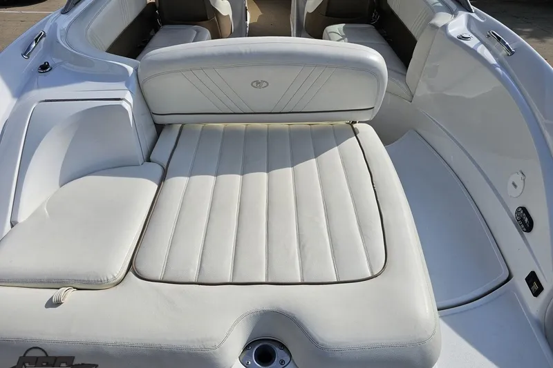 Slide: The Image of 2007 Cobalt 252 boat interior with white cushioned seating and sun pad. - 36