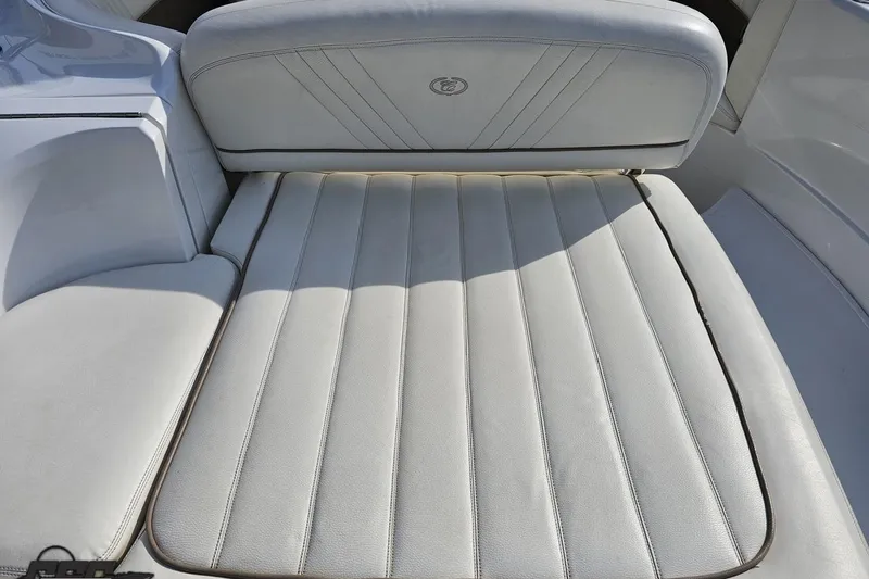 Slide: The Image of 2007 Cobalt 252 boat interior with white cushioned seating and sleek design. - 37