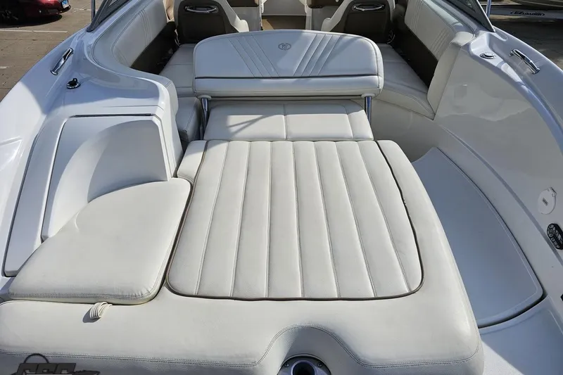 Slide: The Image of 2007 Cobalt 252 boat interior with white leather seating and sun pad. - 38