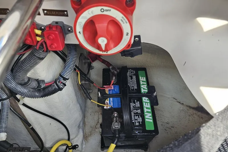 Slide: The Image of Battery compartment of a 2007 Cobalt 252 boat with wiring and switch. - 43