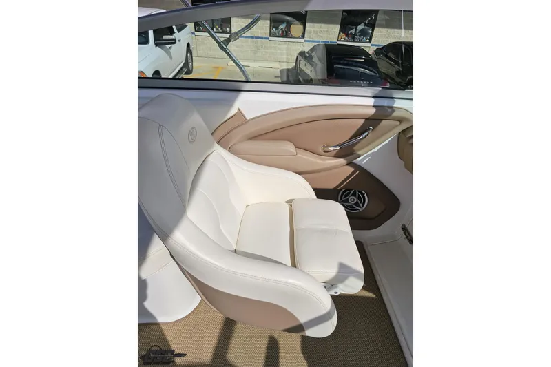 Slide: The Image of Luxurious interior of a 2007 Cobalt 252 boat with beige leather seating. - 53