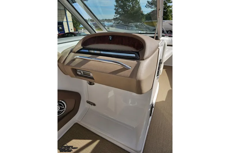 Slide: The Image of 2007 Cobalt 252 boat interior with beige dashboard and speaker detail. - 54