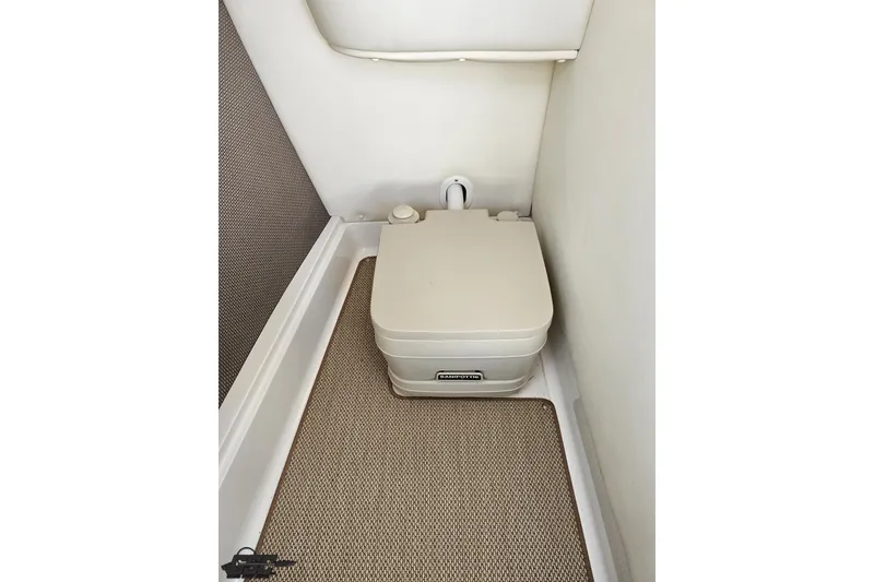 Slide: The Image of Portable toilet in 2007 Cobalt 252 boat interior, beige and compact design. - 58