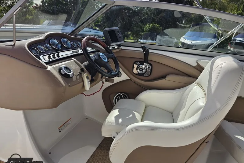 Slide: The Image of Interior of a 2007 Cobalt 252 boat featuring a sleek dashboard and comfortable seating. - 59