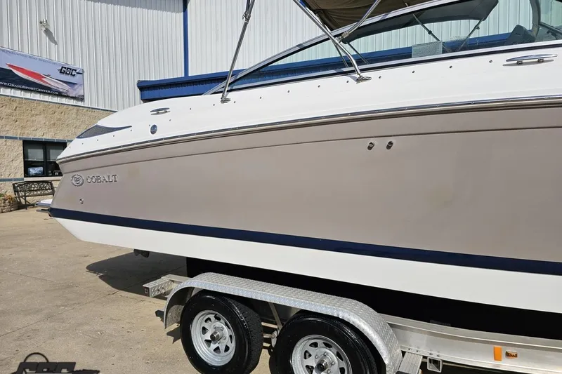 Slide: The Image of 2007 Cobalt 252 boat on trailer, parked outside a building. - 6