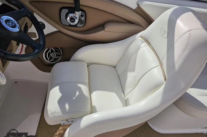 Slide: The Image of 2007 Cobalt 252 boat interior with white leather seat and steering wheel. - 60