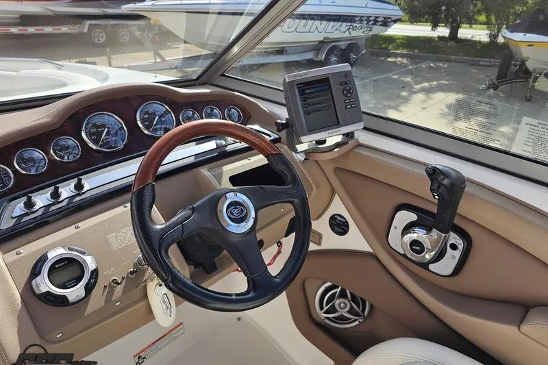 Slide: The Image of 2007 Cobalt 252 boat dashboard with steering wheel, gauges, and Garmin navigation system. - 63