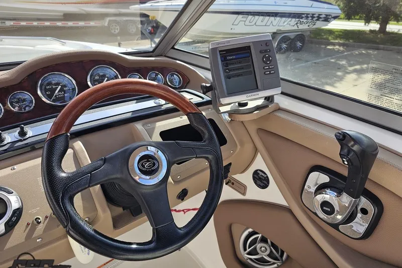 Slide: The Image of 2007 Cobalt 252 boat dashboard with Garmin GPS, steering wheel, and controls. - 64
