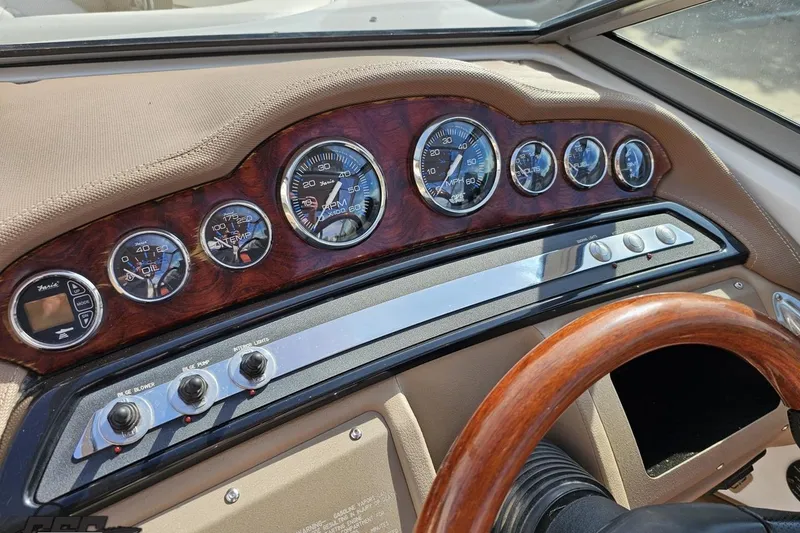 Slide: The Image of Dashboard of a 2007 Cobalt 252 boat with wood accents and gauges. - 65