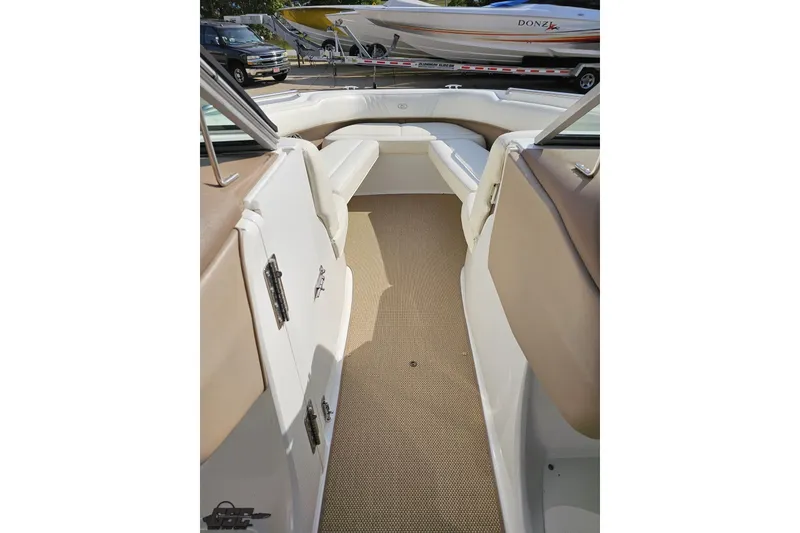 Slide: The Image of 2007 Cobalt 252 boat interior with beige seating and carpeted floor. - 69
