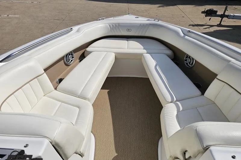 Slide: The Image of 2007 Cobalt 252 boat interior with white leather seating and beige carpet. - 70