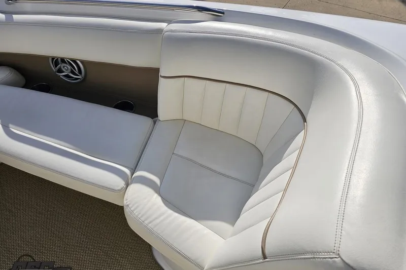 Slide: The Image of Luxurious white seating on a 2007 Cobalt 252 boat, featuring elegant stitching and speaker detail. - 73