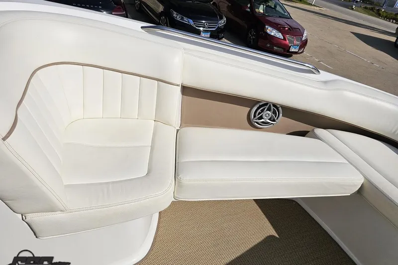 Slide: The Image of 2007 Cobalt 252 boat interior with white leather seating and speaker detail. - 76
