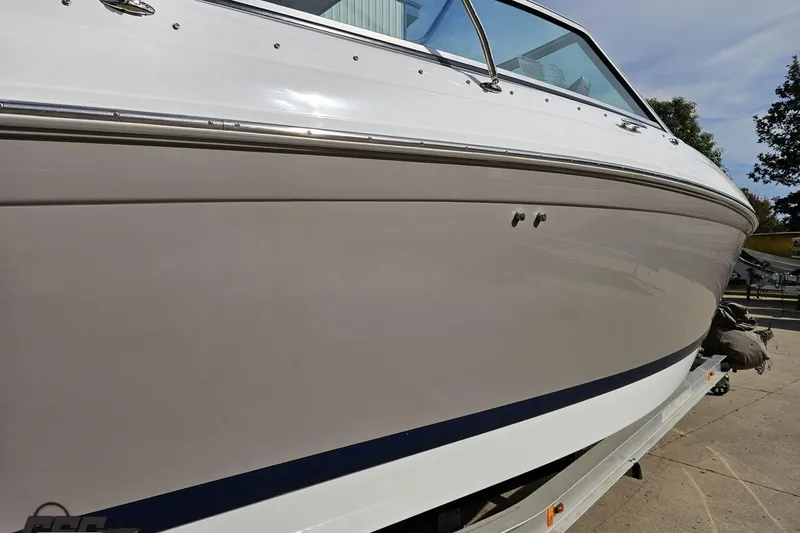 Slide: The Image of 2007 Cobalt 252 boat on trailer, side view, white exterior, sunny day. - 8