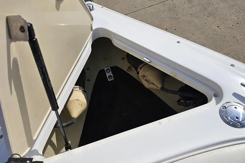 Slide: The Image of Open storage compartment on a 2007 Cobalt 252 boat, showing interior details. - 83
