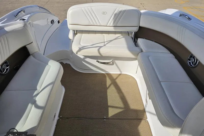 Slide: The Image of Interior of a 2007 Cobalt 252 boat with white seating and beige flooring. - 86