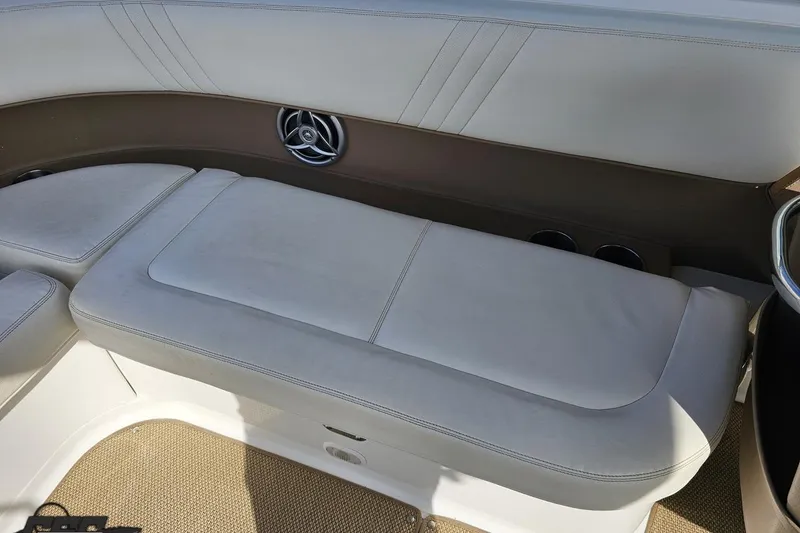 Slide: The Image of 2007 Cobalt 252 boat interior with white cushioned seating and speaker detail. - 87