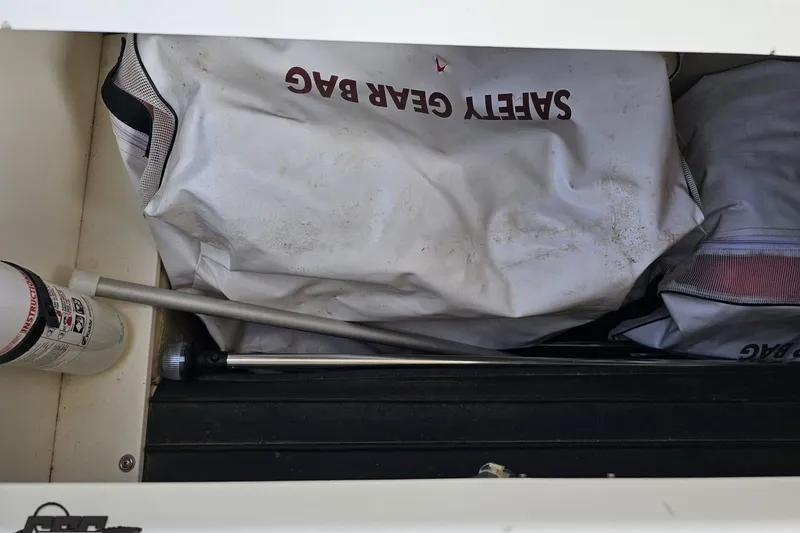 Slide: The Image of Safety gear and equipment stored in a 2007 Cobalt 252 boat compartment. - 88