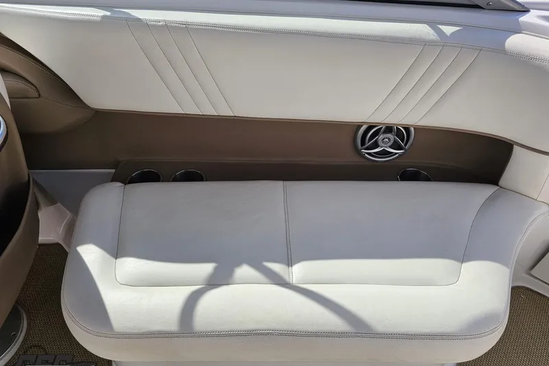 Slide: The Image of 2007 Cobalt 252 boat interior with beige leather seating and cup holders. - 89