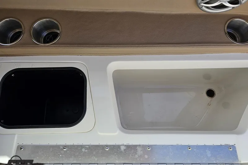 Slide: The Image of 2007 Cobalt 252 boat interior with cup holders and storage compartments. - 90