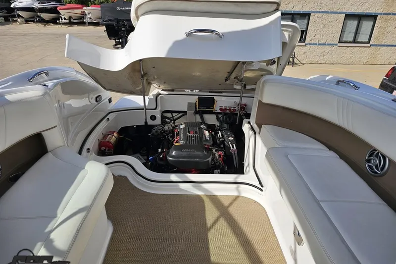 Slide: The Image of 2007 Cobalt 252 boat engine compartment with open hatch, showcasing interior seating and engine details. - 95