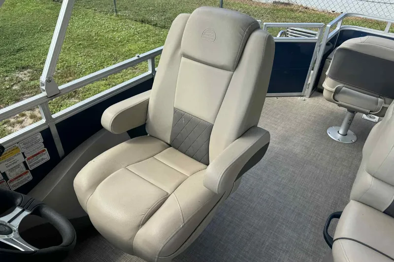 Slide: The Image of 2024 Sun Tracker Fishin' Barge 22 DLX interior with comfortable seating and modern design. - 5