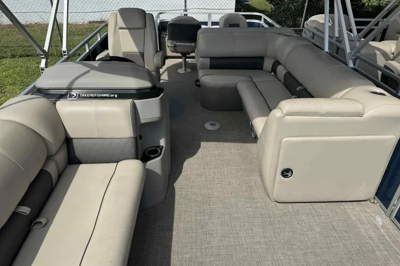 Slide: The Image of 2024 Sun Tracker Fishin' Barge 22 DLX interior with spacious seating and modern design. - 7