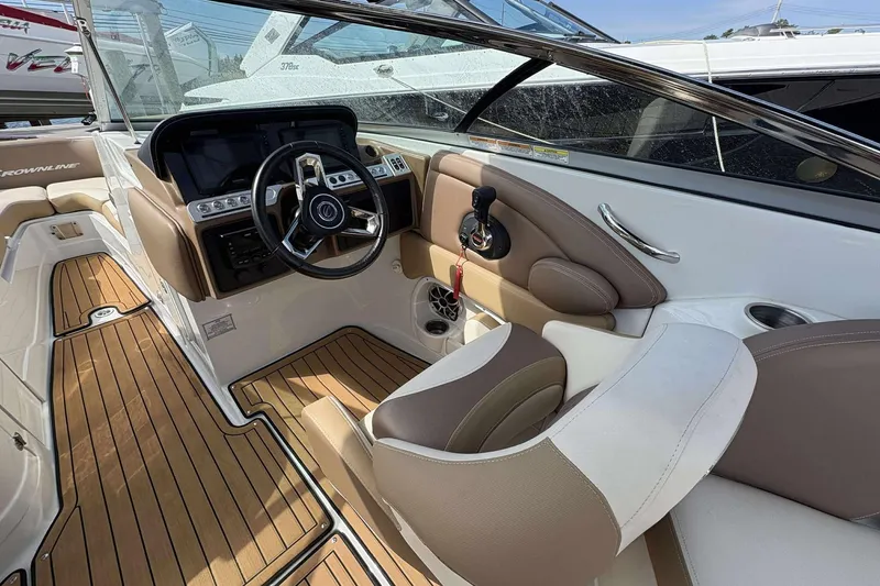 Slide: The Image of 2023 Crownline 280 XSS boat interior with sleek dashboard and comfortable seating. - 11