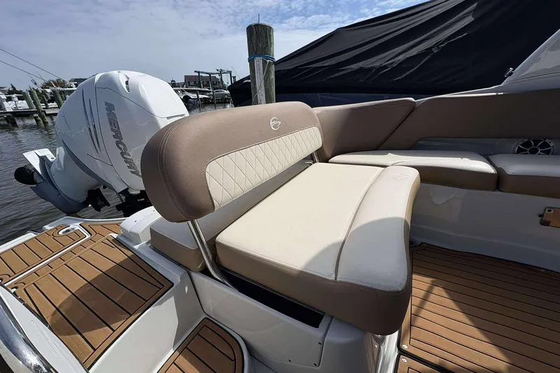Slide: The Image of 2023 Crownline 280 XSS boat interior with Mercury engine, featuring elegant seating and teak flooring. - 12