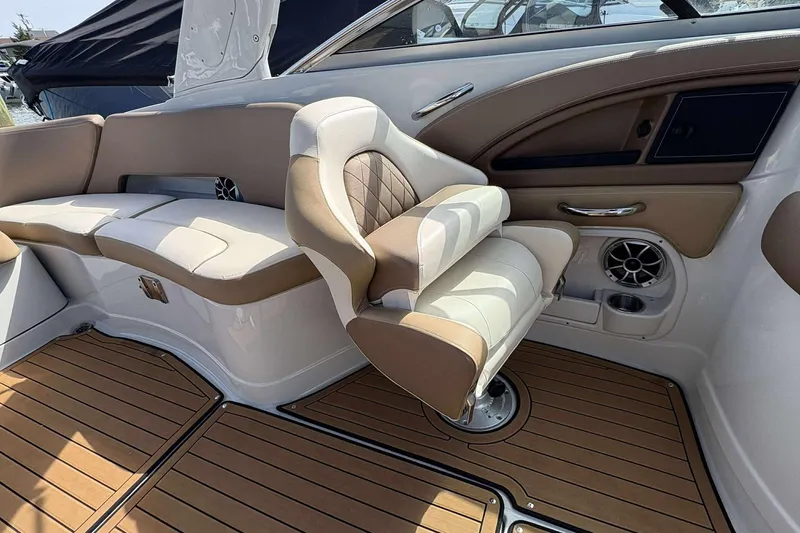 Slide: The Image of 2023 Crownline 280 XSS boat interior with luxurious seating and wood-style flooring. - 14