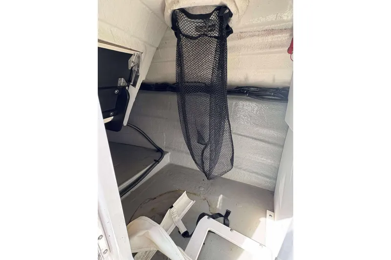 Slide: The Image of Interior storage area of 2023 Crownline 280 XSS boat with netting and equipment. - 15