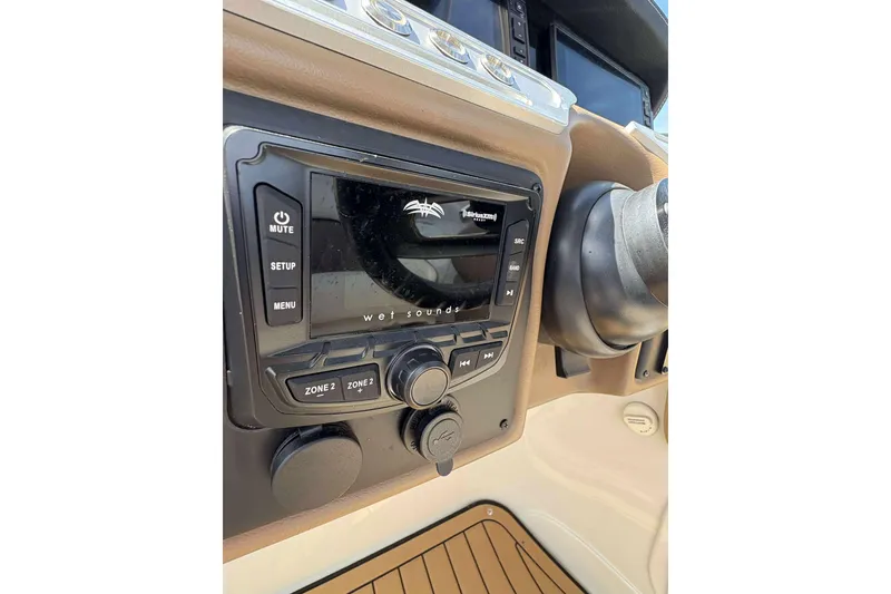 Slide: The Image of 2023 Crownline 280 XSS boat dashboard with audio control panel. - 17