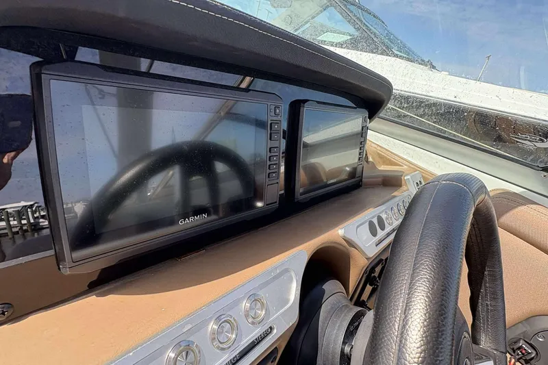 Slide: The Image of Dashboard of 2023 Crownline 280 XSS boat with Garmin displays and steering wheel. - 18
