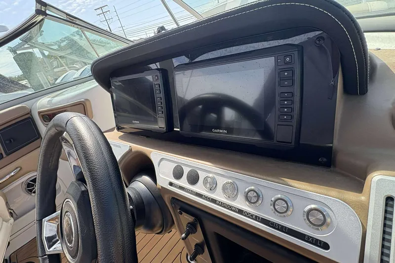 Slide: The Image of 2023 Crownline 280 XSS dashboard with Garmin navigation system and control panel. - 19